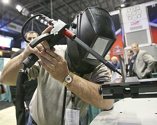 ROBERT K. YOSAY | THE VINDICATOR..trying his hand at virtual welding - As Bill Snyder of Marietta trys his hand at weld - ."The YOUNG 2011 Conference and Expo Ñ the first Utica shale play conference in the state of Ohio Ñ is a dedicated B2B conference in which national and local companies can exhibit their products and interact with key players in the burgeoning Utica and Marcellus supply chain. at the Covelli Centre .. .-30