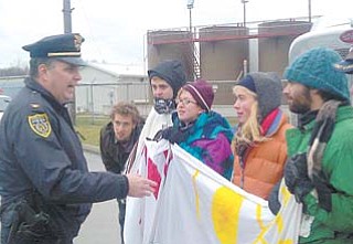 Youngstown Police Chief Rod Foley talks to environmental protesters outside the D&L Energy injection-well site on Ohio Works Drive. Police arrested the protesters Wednesday after they refused to move and allow a truck access to the site.