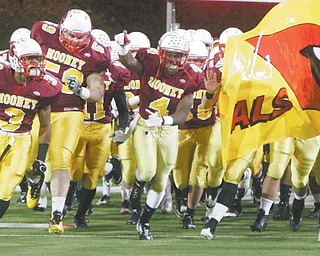 Cardinal Mooney players rush onto the field at Canton’s Fawcett Stadium for the Division III regional final against Dover. The Cardinals will take the field at Fawcett for the final time this season today in the state championship game against Springfield Shawnee.