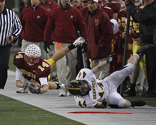 Mooney's #14 Ryan Farragher goes airborne and is pushed out of bounds by Shawnee #44 Ryan Mayfield. Youngstown Cardinal Mooney won their 8th championship as they beat the Shawnee Braves in Fawcett Stadium 21-14. (AP Photo/The Vindicator, Robert K. Yosay)