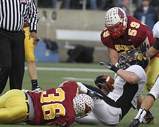 # 36 AjJ Thomas and #59 Austin Turgovich stop Shawnee #6 Alex Mccrory at the line. Youngstown Cardinal Mooney won their 8th championship as they beat the Shawnee Braves in Fawcett Stadium 21-14. (AP Photo/The Vindicator, Robert K. Yosay)