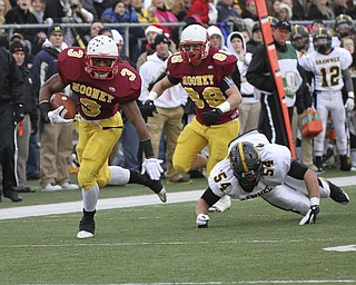 Mooney #3 Roosevelt Griffin eludes Shawnee #54 Lucas Sparks on his way to Mooney's first touchdown. Behind him is #88 Matt Pechia. Youngstown Cardinal Mooney won their 8th championship as they beat the Shawnee Braves in Fawcett Stadium 21-14. (AP Photo/The Vindicator, Robert K. Yosay)