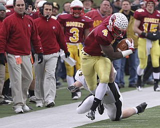 #4 Marcus McWIlson gets pushed out of bounds by Shawnee #14 Dusty Seelig on a runback after a punt in first half action. Youngstown Cardinal Mooney won their 8th championship as they beat the Shawnee Braves in Fawcett Stadium 21-14. (AP Photo/The Vindicator, Robert K. Yosay)