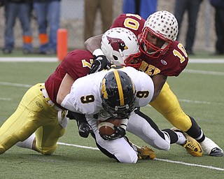 Mooneys #7 Michael Bruno and #10 Justin Ellis Moore bring down Shawnees Jordan Huggins in the backfield for a loss during first half action. Youngstown Cardinal Mooney won their 8th championship as they beat the Shawnee Braves in Fawcett Stadium 21-14. (AP Photo/The Vindicator, Robert K. Yosay)