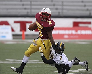 Mooneys #3 Roosevelt Griffin stiff arms and gets away from Shawnee #7 James Williams during first half action. Youngstown Cardinal Mooney won their 8th championship as they beat the Shawnee Braves in Fawcett Stadium 21-14. (AP Photo/The Vindicator, Robert K. Yosay)