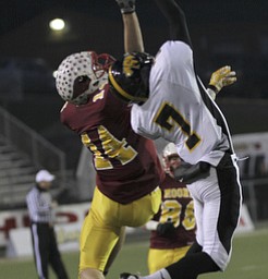 Shawnee #7 James Williams and #14 Mooney Ryan Farragher fight for the ball during second half action. Youngstown Cardinal Mooney won their 8th championship as they beat the Shawnee Braves in Fawcett Stadium 21-14. (AP Photo/The Vindicator, Robert K. Yosay)
