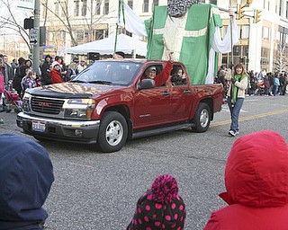 JESSICA M. KANALAS | THE VINDICATOR..Children loon on as the St. Patrick's Church display drives by during the holiday parade in Downtown Youngstown.