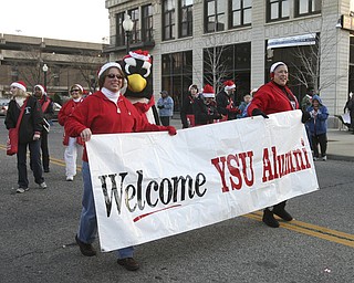JESSICA M. KANALAS | THE VINDICATOR..YSU alumni members walk during the holiday parade in Downtown Youngstown.
