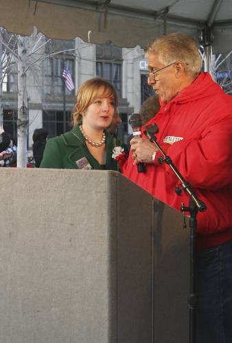 JESSICA M. KANALAS | THE VINDICATOR..SMARTS student Rayne Blakeman, 14, lights the town Christmas tree with Mayor Chuck Sammarone after the holiday parade in Downtown Youngstown.