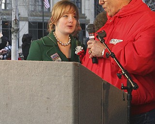 JESSICA M. KANALAS | THE VINDICATOR..SMARTS student Rayne Blakeman, 14, lights the town Christmas tree with Mayor Chuck Sammarone after the holiday parade in Downtown Youngstown.