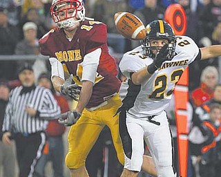Cardinal Mooney’s Ryan Farragher has the ball knocked away by Springfield Shawnee’s Drew Young during the Division III state championship game Friday at Canton’s Fawcett Stadium. The Cardinals held on for a 21-14 victory.