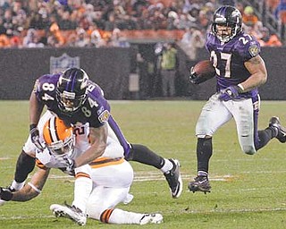 Baltimore running back Ray Rice (27) looks for room to run as tight end Ed Dickson takes out the Browns’ Joe Haden in the second quarter of Sunday’s game in Cleveland. The Ravens won 24-10.