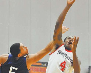 Youngstown State guard Shawn Amiker puts up a shot in front of Fredonia State's Julius Bryany during Tuesday's game at Beeghly Center. Amiker had three points off the bench in a 69-35 win.