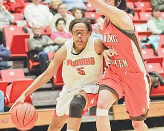 Youngstown State's Kenya Middlebrooks (5) dribbles the ball under the arm of Bowling Green's Chrissy Steffen during Tuesday’s game at Beeghly Center. Middlebrooks scored 15 in the 73-61 loss.