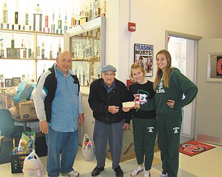 Talking turkey: Students at St. Patrick School in Hubbard donated $100 to the St. Vincent de Paul Society to help buy turkeys for those in need this year. St. Vincent de Paul representatives Mike Heinzer, left, and Dan Williams visited the school to receive the donation from Student Council President Sandy Slenker and Vice President Daelyn Lazor, far right.