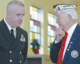 Pearl Harbor survivor Robert Bishop of Austintown, right, talks with Navy Lt. John Hozler during the program Wednesday. Bishop, a Navy veteran, was aboard the USS Tennessee when the bombing occurred. Hozler, commanding officer of the Navy Operational Support Center at Youngstown Air Reserve Station in Vienna, was the speaker for the event at AMVETS Post 44 in Struthers