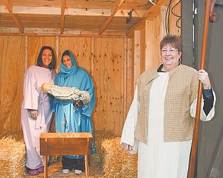From left, Cara Carramusa, Agapi Mantos and Jackie Pauley, all employees at Park Vista Retirement Community on Fifth Avenue, Youngstown, dress up as a part of the live Nativity display outside the Park Vista campus.
Carramusa, Mantos and Pauley took the first 30-minute shift in the manger, just as snow began to fall Wednesday night.