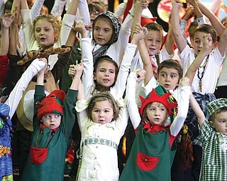 Students at Lloyd Elementary School in Austintown during a final song in the students’ Holiday Around the World program. The show featured facts about the way other cultures celebrate the holidays. More than 100 family members and friends attended the show Thursday.