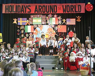 First-grade students at Lloyd Elementary School in Austintown entertain more than 100 friends and family members during their Holiday Around the World program. During the show, the students danced, sang and shared facts about how other cultures celebrate the holidays.