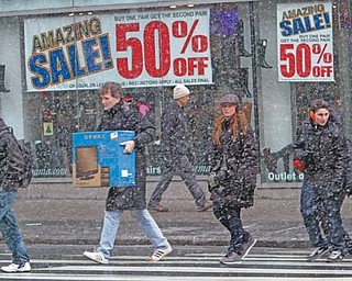 Shoppers make their way in Union Square in New York. Lots of people postpone Christmas celebrations because their jobs don’t pause for the holiday traditionally intended to commemorate the birth of Christ. But in the weak economy, folks are delaying Christmas for another reason: money.