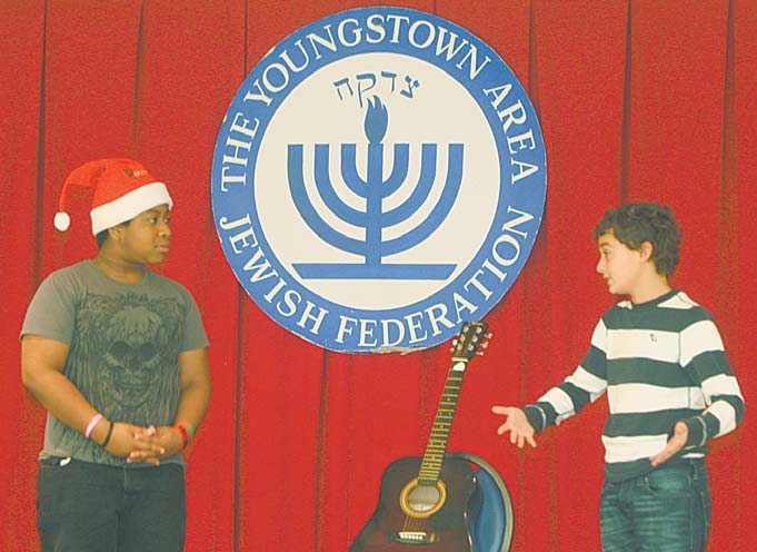 Akiva Academy sixth-grader Ben Shapiro, 12, right, suggests to Santa Claus, played by seventh-grader Eric Allen, 12, that he attend a Hanukkah program to learn about the meaning of the Jewish observance.