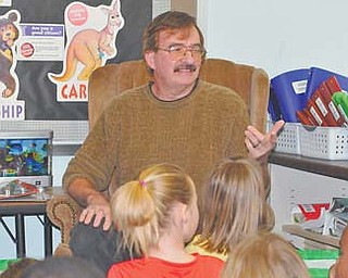 Author James Mallog of Austintown visits with second-graders at Watson Elementary School. Mallog read to the children Monday.