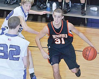 Springfield’s Ron Rogers dribbles around Youngstown Christian defenders Spencer Cornall (33) and Nick Hartman (32) during their basketball game Thursday in Youngstown. The Tigers downed the Eagles, 61-52.