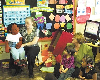 Shown above are Kristen Hartz-McCleery of the D&E Counseling Center, and Wally, a child-sized puppet, teaching preschoolers at Easter Seals in Youngstown. She is assisted by DeLynn Logan of PNC Bank. The counseling center recently received a $10,000 grant from The PNC Foundation, allowing them to provide its Dina Dinosaur program to two preschool classrooms. Hartz-McCleery uses Wally to “talk” to kids about proper behavior, following rules, friendship and other topics. The program is one of several offered by the center’s UPSTREAM Early Child Services designed to help children ages 2 to 8 grow resiliency and emotional health.
