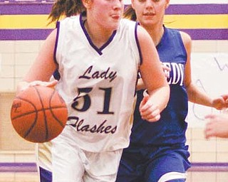 Champion’s Mackenzie Kiser (51) tries to drive around Warren JFK’s Megan Lieber (23) in the third period of their basketball game Monday in Champion. Kiser put up 16 points and was the game’s leading rebounder, but the
Flashes came up short against the Eagles, losing 50-46.