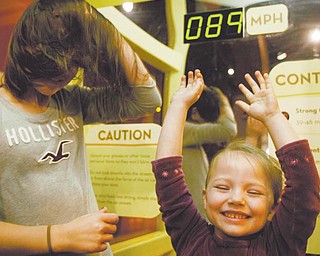 Mary Gomez, 10, of Canfi eld, left, and her cousin, Heidi Bartels, 4, of Salem, experience hurricane-force winds in a wind tunnel at OH WOW! The Roger & Gloria Jones Children’s Center for Science and Technology on West Federal Street downtown. The center, along with the Youngstown Business Incubator, hosted an inaugural Y-Town Tech Tour on Monday.