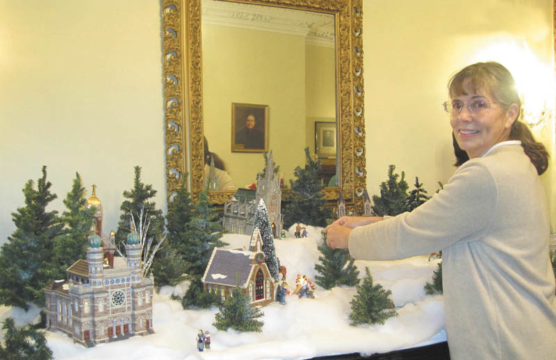 Patricia Burges-Fisher, a docent with the Niles Historical Society, makes final adjustments to the Christmas decorations at the Ward-Thomas Museum, 503 Brown St., Niles. The museum will be open for a final viewing on New Year’s Day from 2 to 5 p.m. Department 56 houses and toys are mingled among old tree decorations and many other items. The President’s Ladies gowns are displayed throughout the museum. For more information call 330-544-2143.