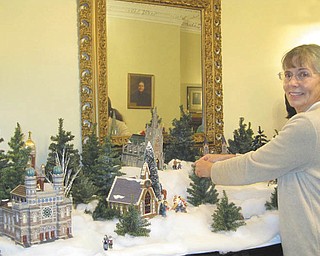 Patricia Burges-Fisher, a docent with the Niles Historical Society, makes final adjustments to the Christmas decorations at the Ward-Thomas Museum, 503 Brown St., Niles. The museum will be open for a final viewing on New Year’s Day from 2 to 5 p.m. Department 56 houses and toys are mingled among old tree decorations and many other items. The President’s Ladies gowns are displayed throughout the museum. For more information call 330-544-2143.