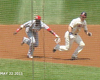 Travis Buck of the Cleveland Indians is avoiding the tag in a rundown against the Cincinnati Reds on May 22, 2011, in this photo taken by Shelly Toth of Austintown.