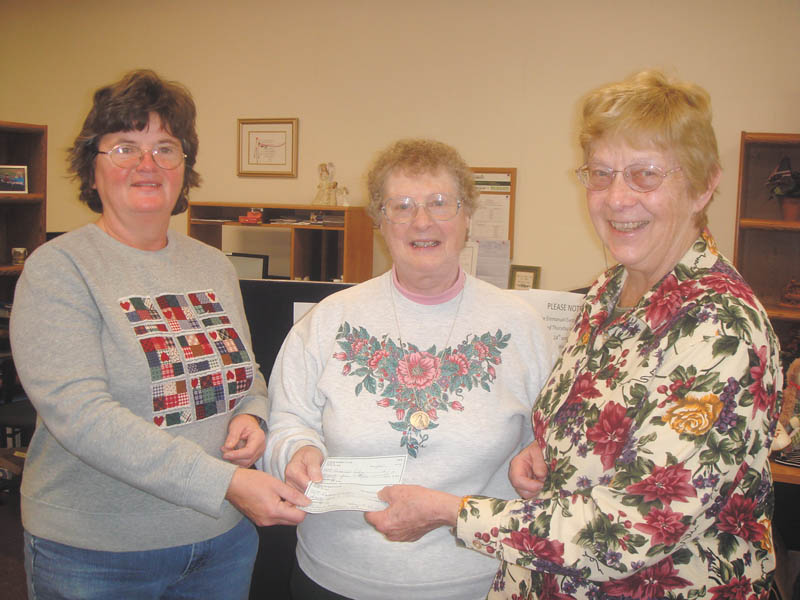 Roberta Lawrentz, center, of Girard Junior Womens League, presents donations to Sister Midge, left, and Sister Marjorie of Emmanuel Care Center. The center is dedicated to providing for needy families in Girard. Four-hundred bags of food and IGA gift certificates were donated at Thanksgiving, and the center plans to give 600 gifts at Christmas to qualifying families. Girard Junior Women is a nonprofit group; new members are welcome.