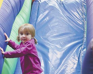 Lauren Ross, 5, of Canfield, at top, and Olivia Truby, 2, of Texas, play on a slide that is part of an obstacle course at Austintown Bounce on Kirk Road. Many children are taking advantage of the holiday school break to play this week at the indoor facility and other kid-friendly businesses in the Mahoning Valley.