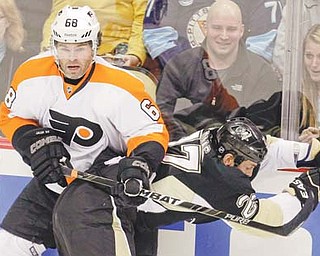 The Philadelphia Flyers’ Jaromir Jagr (68) collides with the Pittsburgh Penguins’ Craig Adams (27) in the first period of an NHL game Thursday in Pittsburgh. Jagr and Max Talbot, both former Penguins, each scored a goal to help lift the Flyers over Pittsburgh, 4-2.