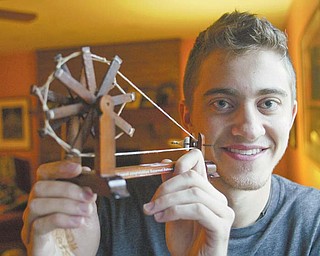 Ben Stoyak holds a replica of a spinning wheel he brought back from a recent trip to India. Stoyak’s trip was part of an honors course at the University of Cincinnati in which he traveled for two weeks to villages on the west side of the country and studied the impact of their access to clean water.