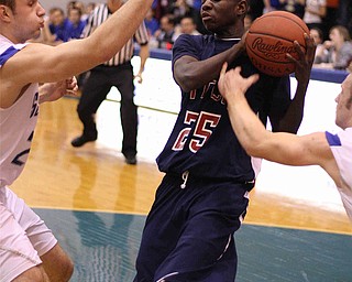 DUSTIN LIVESAY | THE VINDICATOR 

Jessie Driver (25) of Fitch pulls down a rebound between Eddie Moore (25,Left) and Quincy Higgins (22) of Poland during second period action on Friday night in Poland.