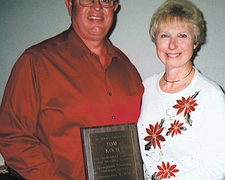 Appreciation award presented at dinner: Tom Koch, left, received the 2011 Appreciation Award from the Springfield Township Historical Society at their Christmas dinner Dec. 11. President Zonda Haase, right, presented
the plaque, citing the service Koch has given in maintaining the
meeting house and working with his father, Raymond Koch, who is
a trustee. The event was hosted by Don and Kari Snyder at their home.