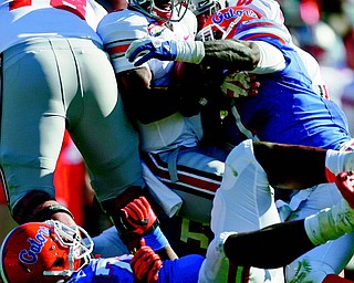Florida’s Ronald Powell (7) sacks Ohio State quarterback Braxton Miller (5) in the first half of the Taxslayer.com
Gator Bowl at Everbank Field on Monday in Jacksonville, Fla. The Gators’ defense and special teams came up big,
recording six sacks and scoring twice as Florida downed the Buckeyes, 24-17.