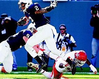 Penn State running back and Mooney graduate Michael Zordich (9) moves in to assist teammate Chaz Powell (2) as Powell is pursued by Houston running back Braxton Welford (40) during the second half of the TicketCity Bowl on Monday at the Cotton Bowl in Dallas. The No. 20 Cougars rolled over the No. 24 Nittany Lions, 30-14, behind quarterback Case Keenum, who completed 45 of 69 passes for 532 yards.