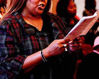 Lillian Howell of Youngstown sings along with the congregation during the service. The annual event celebrates the 1863 signing of the Emancipation Proclamation, which freed slaves in America.