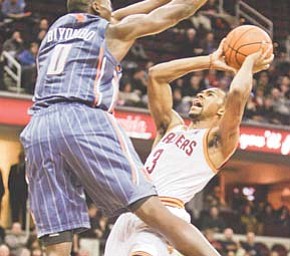 The Cavaliers’ Ramon Sessions (3) is stopped by the Bobcats’ Bismack Biyombo (0) in the second quarter of Tuesday’s NBA basketball game in Cleveland.