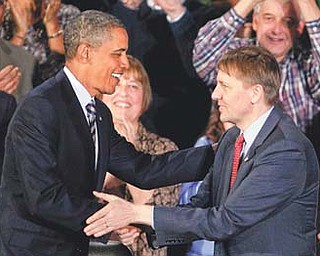 President Barack Obama shakes hands with Richard Cordray in Shaker Heights, Ohio. In a defiant display of executive power, Obama on Wednesday bucked GOP opposition and appointed Cordray as the nation’s chief consumer watchdog.