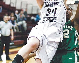 Boardman’s Emily Gibbs (34) leaps past Ursuline’s Courtney Powell on the way to the hoop during the first quarter of Wednesday’s game at Boardman High School.