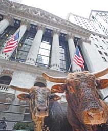A pair of bulls is displayed in front of the New York Stock Exchange on Thursday to promote the Professional Bull Riders annual event at Madison Square Garden. Stocks steadily gained ground Thursday after falling sharply at the open. Investors weighed renewed concern about Europe against the latest encouraging report about the U.S. job market.