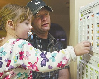 Chloe Baer, 2, and her father Matt Baer, of Poland, log Chloe’s healthy eating habits using her An Apple A Day tracking tool. Baer said the program, which he also uses with his 7-year-old daughter, Brianna, helps him keep track of what his children are eating and gets them involved in their own nutrition.