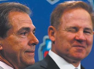 LSU head coach Les Miles, right, and Alabama head coach Nick Saban pose for a picture during a news conference for the BCS national championship game in New Orleans.