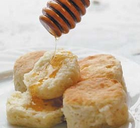 Callie’s Charleston Biscuits are shown with a drizzle of honey.