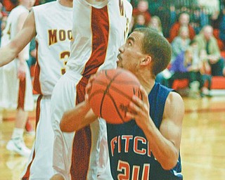 Fitch’s Nate Blair (24) looks for room as Mooney’s Doug Caputo closes in under the Mooney basket during Tuesday’s game at Mooney. The Falcons won, 47-46.